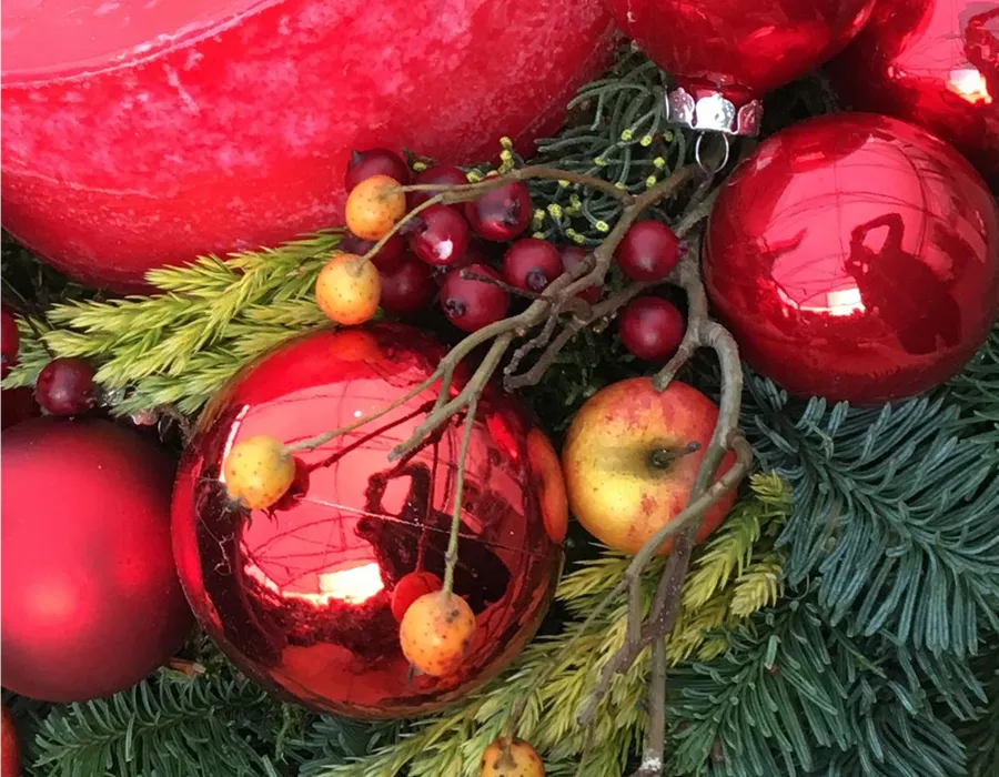 Adventsdekoration mit echtem Grün Rote Christbaumkugeln mit Tannengrün und Beeren